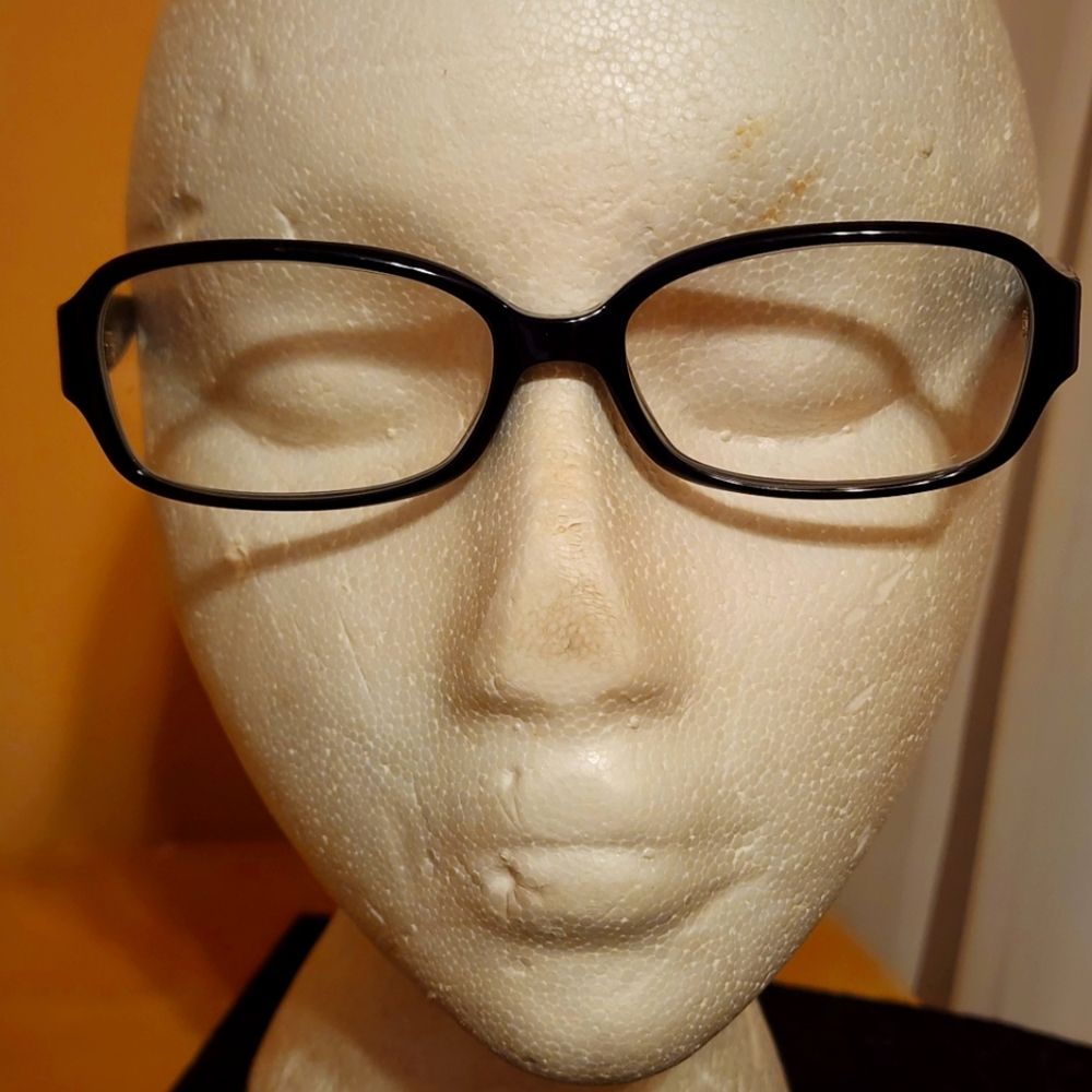 A pair of Coach Gloria Dark Tortoise 5002 eyeglasses.